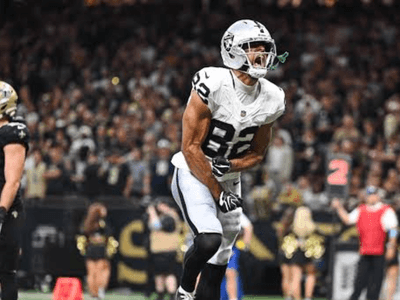 Football player celebrates a touchdown during an NFL game in a stadium